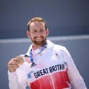 Bronze medallist Britain's Declan Brooks stands on the podium for the victory ceremony of the cycling BMX freestyle men's park event at the Tokyo 2020 Olympic Games in Tokyo on August 1, 2021. Photo by Jeff PACHOUD / AFP and JEFF PACHOUD/AFP via Getty Images.
