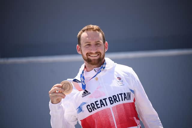 Bronze medallist Britain's Declan Brooks stands on the podium for the victory ceremony of the cycling BMX freestyle men's park event at the Tokyo 2020 Olympic Games in Tokyo on August 1, 2021. Photo by Jeff PACHOUD / AFP and JEFF PACHOUD/AFP via Getty Images.