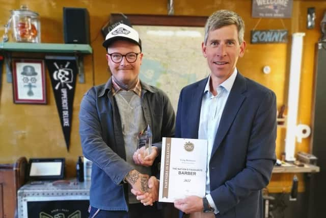 Craig Robinson and Gareth Penn with the certificate celebrating Craig's new title of Good Salon Guide Nation’s Favourite Barber.