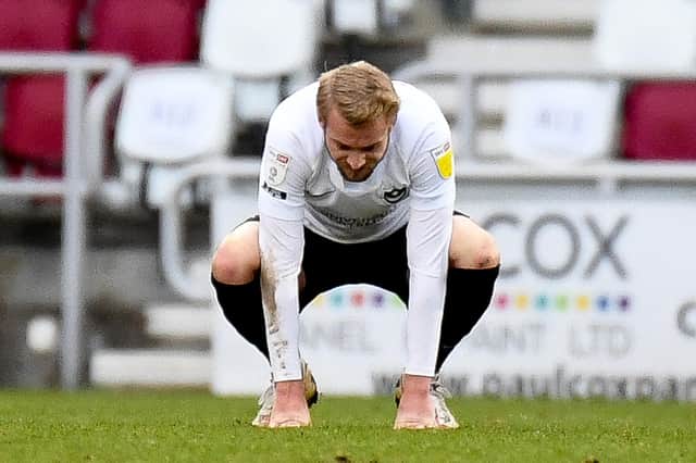 Portsmouth FC defender Jack Whatmough (6) looks dejectedduring the EFL Sky Bet League 1 match between Northampton Town and Portsmouth at the PTS Academy Stadium, Northampton, England on 6 March 2021. Pixture: Dennis Goodwin