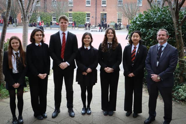 Mr David Wickes, Head of The Portsmouth Grammar School with the pupils who have secured offers from Oxford and Cambridge.