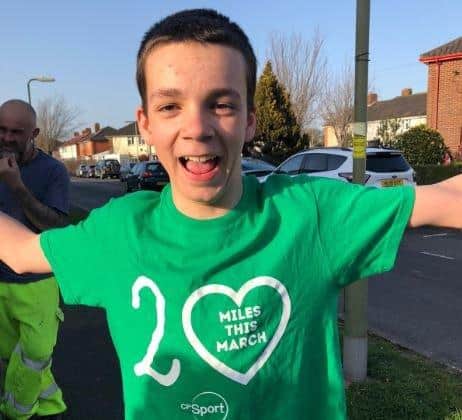 Jack Cowley, 12, celebrates completing his 20 mile challenge for Cerebral Palsy Sport.