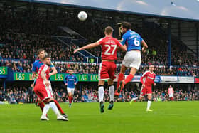 Christian Burgess (6) of Portsmouth challenges for a header during the EFL Sky Bet League 1 match between Portsmouth and Gillingham at Fratton Park, Portsmouth, England on 12 October 2019.