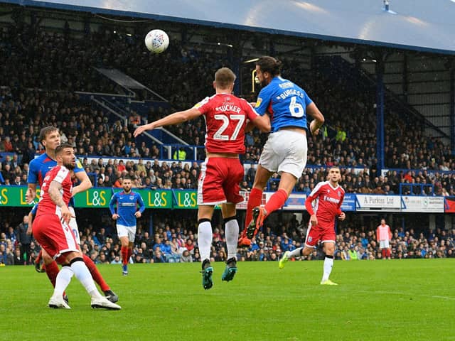 Christian Burgess (6) of Portsmouth challenges for a header during the EFL Sky Bet League 1 match between Portsmouth and Gillingham at Fratton Park, Portsmouth, England on 12 October 2019.