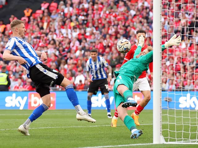 Harry Isted thwarts Sheffield Wednesday's Michael Smith in the League One play-off final at Wembley. Picture: Catherine Ivill/Getty Images