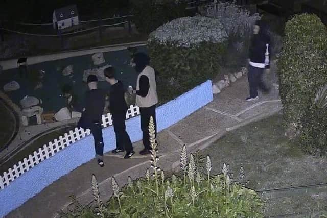 Four youths broke into Southsea Model Village, in the early hours of yesterday, posing for pictures in front of the buildings. A figure of a disabled child in a wheelchair is reported to have been stolen. Picture: Southsea Model Village.