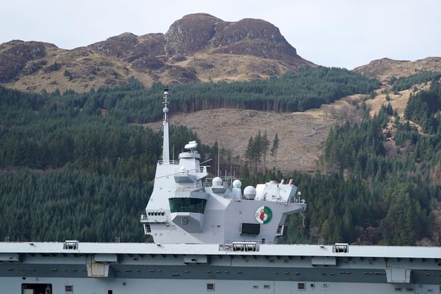 The Royal Navy aircraft carrier HMS Queen Elizabeth leaving Glen Mallan in Loch Long with the Arrochar Alps behind.