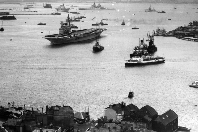 HMS Victorious leaving Portsmouth Harbour  in 1958. Above her is the battleship HMS Vanguard. (Robin Kay collection)