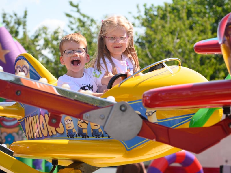 River and Harper Hall enjoy the fair ground ride at the Party in the Park.Picture: Keith Woodland (270721-11)