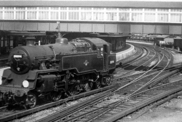 Looking down from Goldsmith Avenue towards Fratton Station footbridge 1960. Here we see a Standard class 2-6-4 travelling tender first into the depot. Notice the covering of the footbridge now a long gone feature.