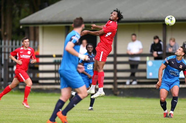 Horndean's Jean-Pierre Alexander (red) in action against Hartley Wintney. Picture: Chris Moorhouse