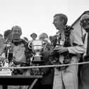 13th September 1958:  Stirling Moss (left) and co-driver Tony Brooks with the trophy after winning the Tourist Trophy Sports Car Race at Goodwood.  (Photo by Keystone/Getty Images)