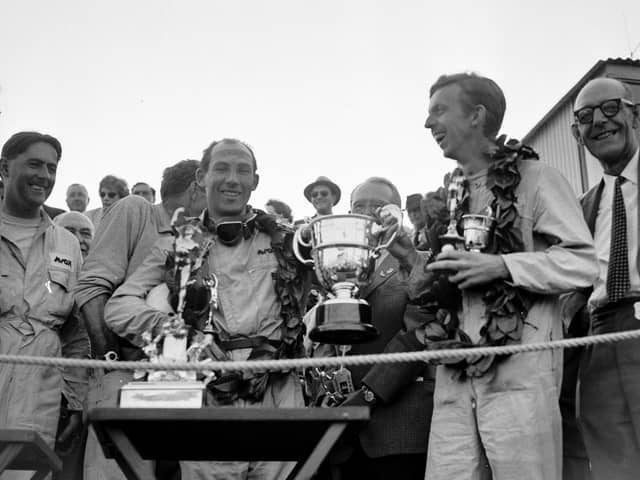 13th September 1958:  Stirling Moss (left) and co-driver Tony Brooks with the trophy after winning the Tourist Trophy Sports Car Race at Goodwood.  (Photo by Keystone/Getty Images)