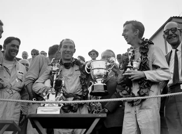 13th September 1958:  Stirling Moss (left) and co-driver Tony Brooks with the trophy after winning the Tourist Trophy Sports Car Race at Goodwood.  (Photo by Keystone/Getty Images)