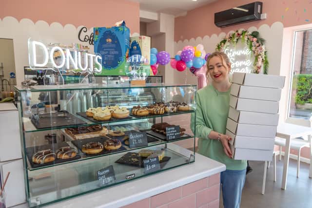 Lauren England (19) keeps the shelves filled at Cake'o'Nuts in Cosham. Picture: Mike Cooter (08042023)