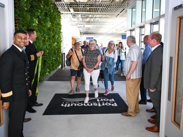 The first passengers enter through the new terminal