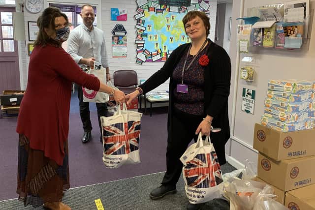 Dr Emma Maynard (left) delivers food parcels to Oliver Hext, business manager at Cottage Grove Primary School, and headteacher Polly Honeychurch.