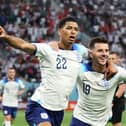 England midfielder Jude Bellingham celebrates scoring England's first goal at the 2022 World Cup with Pompey fan and Three Lions team-mate Mason Mount.   Picture: Clive Brunskill/Getty Images