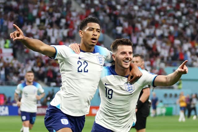 England midfielder Jude Bellingham celebrates scoring England's first goal at the 2022 World Cup with Pompey fan and Three Lions team-mate Mason Mount.   Picture: Clive Brunskill/Getty Images