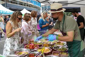 Natalia Yakovleva, left, chooses mixed olives and peppers. Southsea Food Festival on Palmerston, Clarendon and Osborne Roads
Picture: Chris  Moorhouse (200724-29)