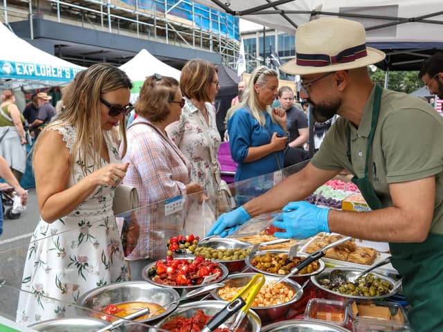 Natalia Yakovleva, left, chooses mixed olives and peppers. Southsea Food Festival on Palmerston, Clarendon and Osborne Roads
Picture: Chris  Moorhouse (200724-29)
