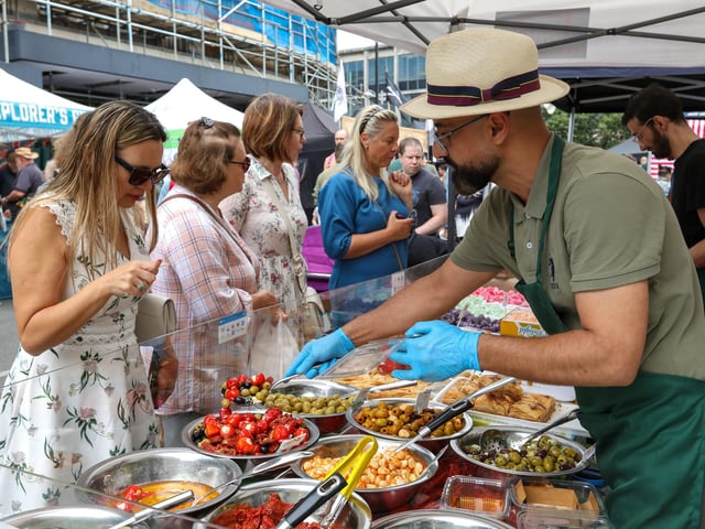 Natalia Yakovleva, left, chooses mixed olives and peppers. Southsea Food Festival on Palmerston, Clarendon and Osborne RoadsPicture: Chris  Moorhouse (200724-29)