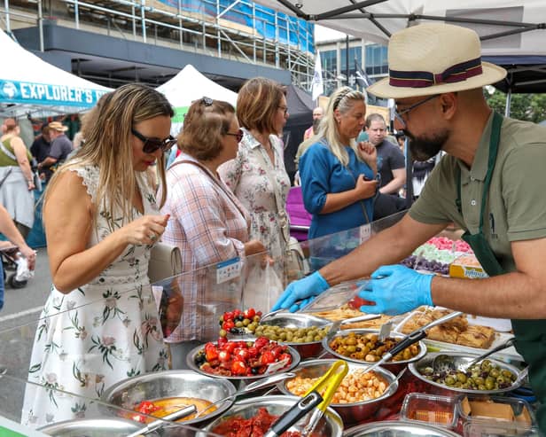 Natalia Yakovleva, left, chooses mixed olives and peppers. Southsea Food Festival on Palmerston, Clarendon and Osborne Roads
Picture: Chris  Moorhouse (200724-29)