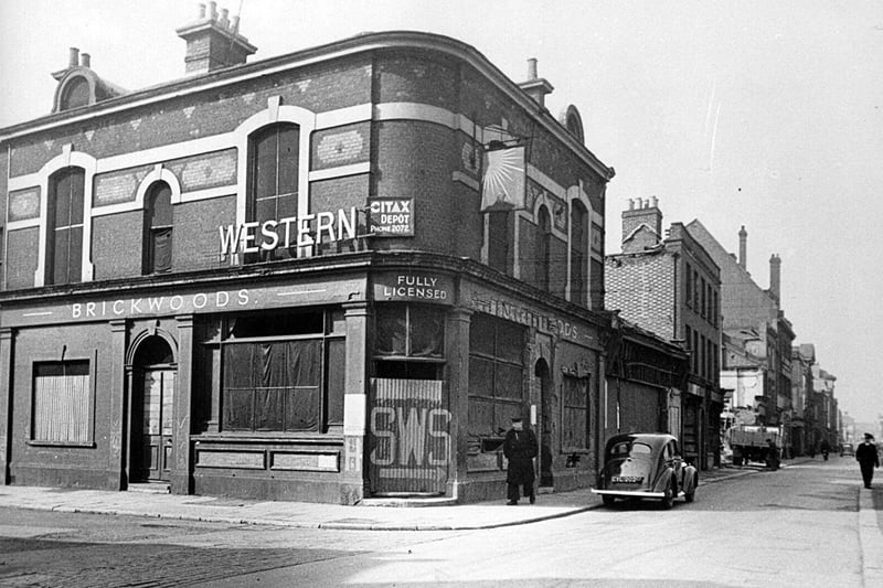 The Western pub. A marvellous view down Queen Street before it was widened and we see the former Western public house. The painted sign on the door  SWS, Static Water Supply were to be seen all over the city and can still be seen on some locations.