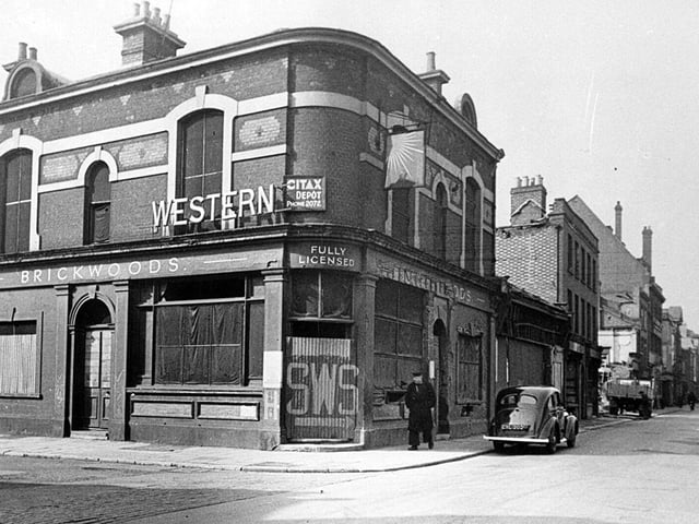 The Western pub. A marvellous view down Queen Street before it was widened and we see the former Western public house. The painted sign on the door  SWS, Static Water Supply were to be seen all over the city and can still be seen on some locations.