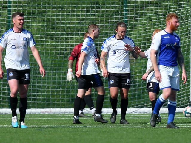 Clanfield's captain Jake Knight, second right, has just put his side 2-1 up from the penalty spot. Picture: Chris Moorhouse
