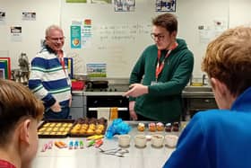 David Knight and apprentice Oscar from the Royal Maritime Hotel share hands on cake decorating skills with aspiring young chefs.
