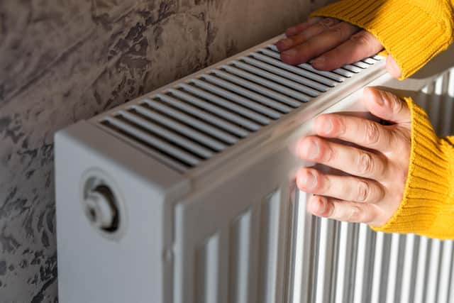 Warming hands on the radiator.