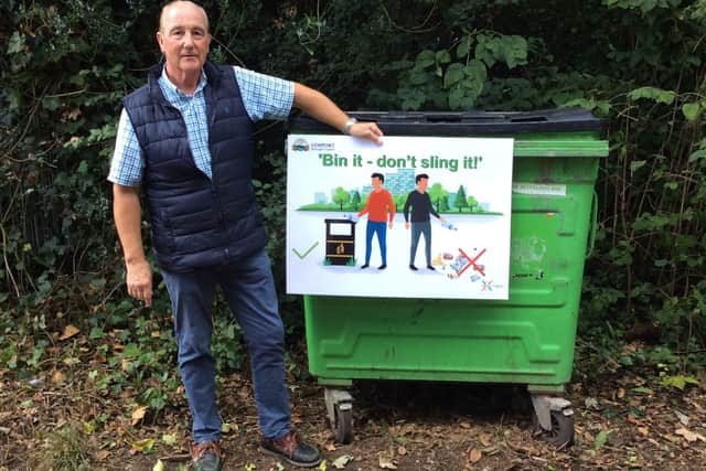 Cllr Philip Raffaelli, who chairs Gosport Borough Council's Community Board, in Stanley Park with one of the borough's new anti-litter posters.