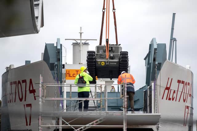 A Churchill Crocodile tank is craned onto the restored World War Two landing craft LCT 7074 outside The D-Day Story in Southsea, Hampshire. Andrew Matthews/PA Wire