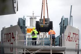 A Churchill Crocodile tank is craned onto the restored World War Two landing craft LCT 7074 outside The D-Day Story in Southsea, Hampshire. Andrew Matthews/PA Wire