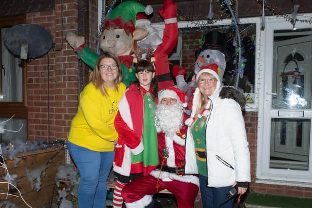 Charlotte Fairall, Billie Lee, and Karen Brogan with Portchester's Santa. Picture: Keith Woodland (181221-27)