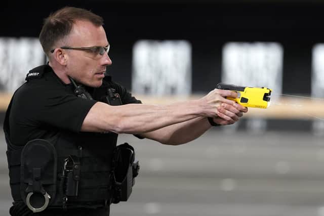 An officer demonstrates the new Taser 7 as Hampshire and Isle of Wight Constabulary and Thames Valley Police launch the rollout of new Taser devices, at Sulhamstead Police Training Centre. The Taser 7 device is an evolution of its predecessor, enhancing the safety of our officers and the public, with two cartridge types for use depending on the proximity of a person. Picture: Andrew Matthews/PA Wire.