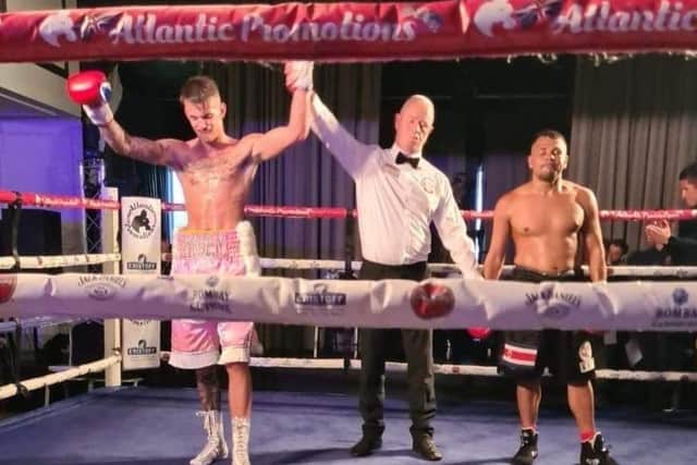 Liam Wiseman is declared the points winner against Berman Sanchez and has his had raised on South Parade Pier