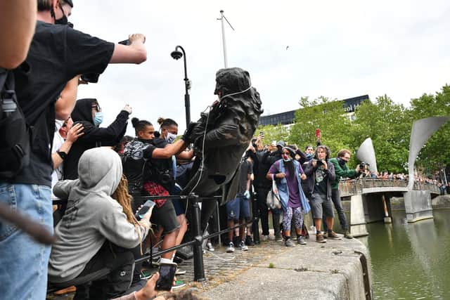 Protesters throw statue of Edward Colston into Bristol harbour during a Black Lives Matter protest rally. Picture: Ben Birchall/PA Wire