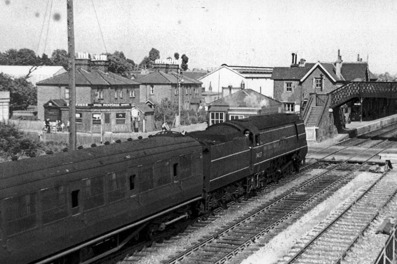 Light Pacific at Cosham. Passing Cosham signal box in 1950 we see a West Country/Battle of Britain class locomotive at the head of a train from the west.