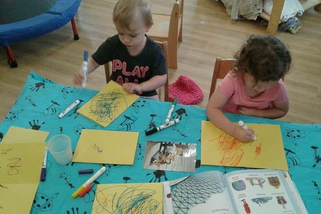 Children from Tops Day Nurseries create condolence cards.