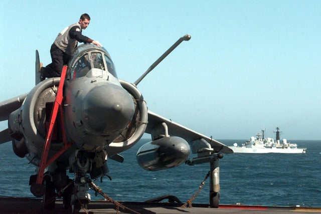 AEM Alan Clements from Taunton readies a Sea Harrier on HMS Invincible with escort HMS Newcastle (in background) Saturday April 17, 1999, as the  aircraft carrier joins NATO forces off the Balkan coast. PA photo: Tim Ockenden