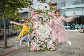 Children enjoying the flower installations at Whiteley Shopping Centre in Fareham