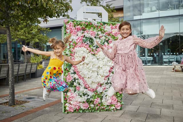 Children enjoying the flower installations at Whiteley Shopping Centre in Fareham