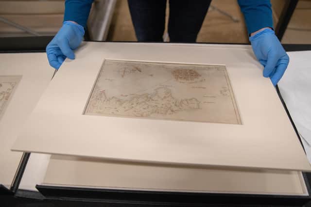 Victoria Ingles, senior curator at the National Museum of the Royal Navy, looks at one of the 'Armada Maps' at Portsmouth Historic Dockyard. Photo: Andrew Matthews/PA Wire
