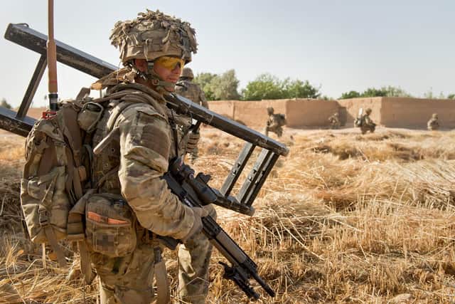 Soldiers from 2 Royal Anglians (The Poachers) and 9/12 Lancers pictured conducting a disruption operation to the West of Camp Bastion with the Afghan National Army (ANA) in May 2014. Photo: Cpl Daniel Wiepen