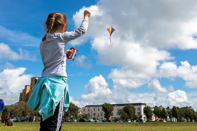 Anna Martin (7) making the most of the brisk seafront breeze at the Portsmouth Kite Festival. Picture: Mike Cooter (070821)