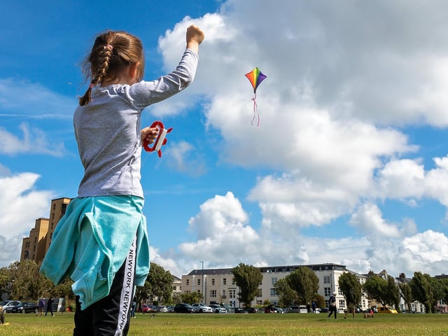 Anna Martin (7) making the most of the brisk seafront breeze at the Portsmouth Kite Festival. Picture: Mike Cooter (070821)