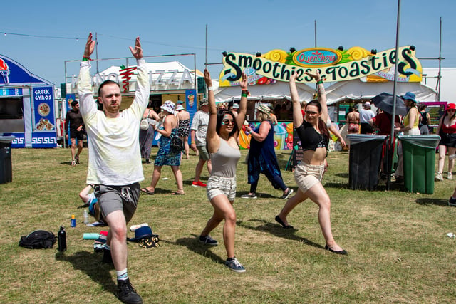 The Isle Of Wight Festival in Seaclose Park 2022. Pictured is: (l-r) Sam March, Monica Chand and Valerija Jurgaityte doing yoga. Picture: Emma Terracciano