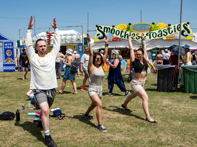 The Isle Of Wight Festival in Seaclose Park 2022. Pictured is: (l-r) Sam March, Monica Chand and Valerija Jurgaityte doing yoga. Picture: Emma Terracciano